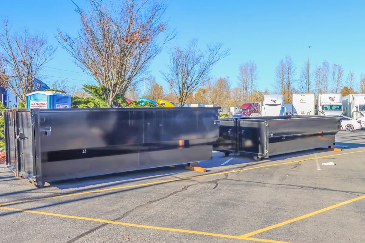 Professional dumpster rental service with roll-off container on residential driveway in Pendleton